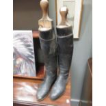 A pair of leather riding boots and trees