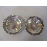 A pair of silver circular pin trays by Adie Brothers, Birmingham 1946 with shell and scroll borders,