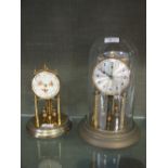 Two anniversary clocks, one under dome