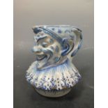 A Delft blue and white mug, modelled an Puncinello, 'VK' mark to base, 16cm high