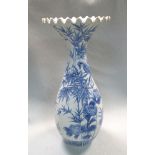 An early 20th century Arita blue and white vase, the flared frilled rim above a slender ovoid body