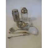 A continental silver wine taster, slice, sugar tongs and spoon, two silver mounted glass bottles and