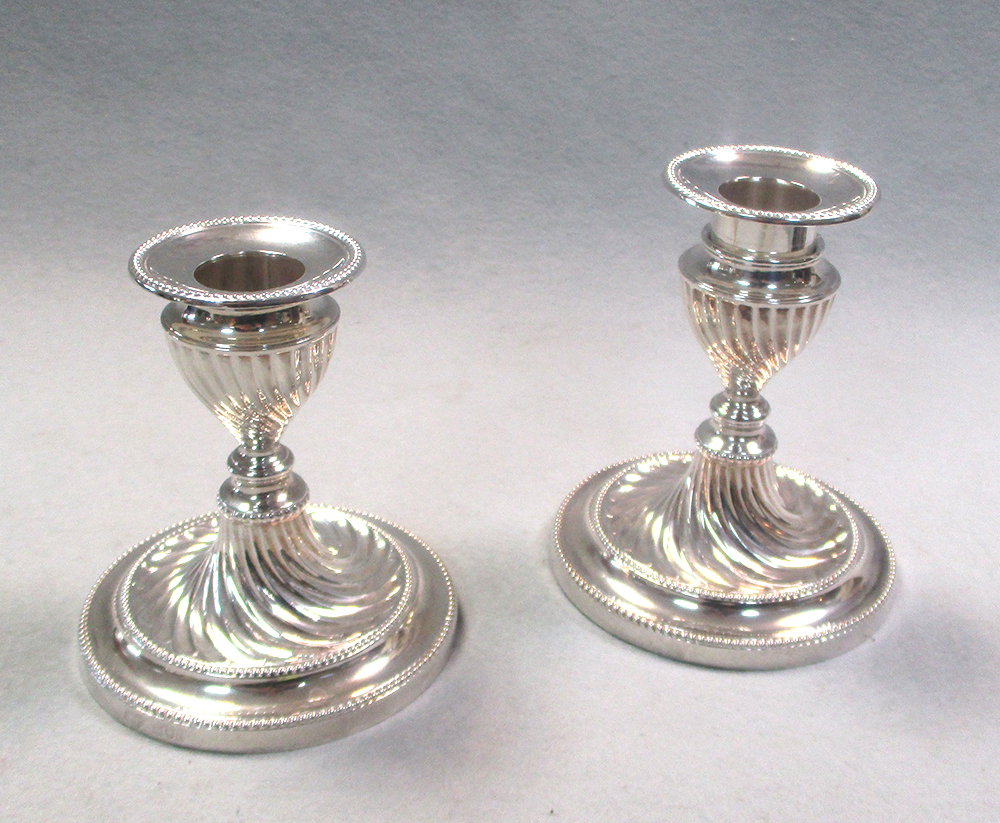 A pair of silver dwarf candlesticks by the Goldsmiths and Silversmiths Company, London 1910, with