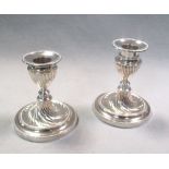 A pair of silver dwarf candlesticks by the Goldsmiths and Silversmiths Company, London 1910, with