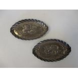 A pair of silver oval pin trays by Deakin and Francis, Birmingham 1897, decorated with cherubs, 13cm