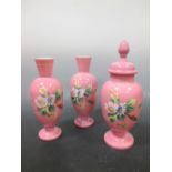 A Victorian pink glass garniture