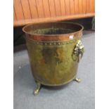 A copper and brass cauldron log bin