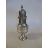 A large silver sugar caster Birmingham 1938, 23cm (9in) high decorated with symmetrical strapwork,