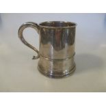 A George V silver tankard, Birmingham 1929, in George III style with moulded girdle and scrolled