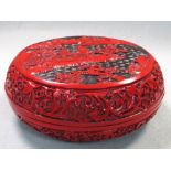 A Chinese moulded cinnabar box and cover, 19cm (7.5 in) diameter (2)