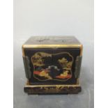 A Japanese inlaid black lacquer miniature cabinet and stand
