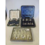 A cased set of sterling silver teaspoons, the terminals cast with oriental motifs; a cased set of