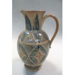 Frank Butler for Doulton Lambeth, a stoneware jug, with incised quatrefoil motifs within foliate