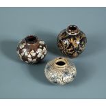 Three miniature Martin Brothers stoneware vases, each decorated with scrolling foliate motifs and