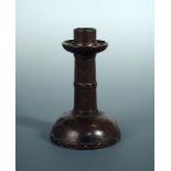 A Royal Doulton stoneware simulated copper candlestick, the 'riveted' column above a domed base,