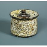 A Martin Brothers stoneware inkwell, with detachable cover, the body with scrolling vines and