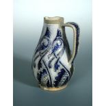 A Martin Brothers stoneware jug, incised and glazed in dark blue to a paler blue ground, inscribed