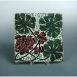 William de Morgan, a large Sand's End tile, painted with vine leaves and grapes, impressed mark 20 x