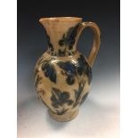 Frank Butler for Doulton Lambeth, a stoneware jug, with incised and glazed foliate decoration,