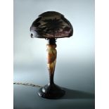 Daum, Nancy, a good cameo glass table lamp, circa 1910, with wrought iron fittings, the shade signed