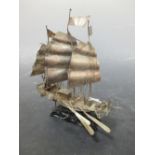 A Chinese 'silver' marked model sailing junk on wood stand Oars a bit bent Looks like some minor