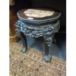 A 19th century Chinese marble topped hardwood urn stand