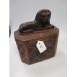 A carved oak caddy box with a carved figure of a recumbent lion to the top, 20 x 13 cms