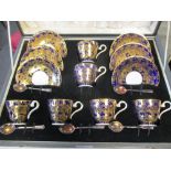 An Aynsley cased coffee service for six, the cobalt blue borders gilt with foliage, with five silver