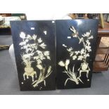 A pair of Japanese black lacquer panels inlaid with flowers