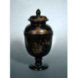 An early 19th century German chinoiserie lacquered wood ovoid urn and cover, the latter with acorn