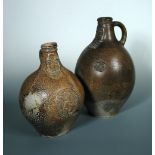 A large 17th century Bellarmine jug, the kneck typically moulded, the ovoid body moulded with