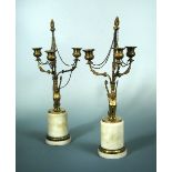 A pair of early 19th century French gilt bronze three light candelabra, centred by fruiting