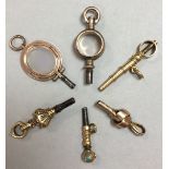 A collection of six pocket watch keys, including one articulated moonstone set and one with an