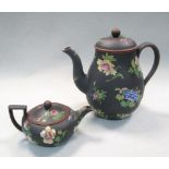 A 19th century Wedgwood black basalt coffee pot and cover and teapot and cover, enamelled with