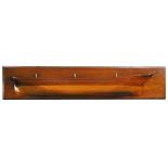 A late 19th century mahogany half model of the hull of HMS Endymion, the backing board 143 x 29cm (