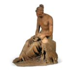 An early 19th century Italian terracotta group of Hebe and the eagle, she sits scantily draped