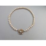A uniform cultured pearl necklace with pearl and diamond clasp, the 7.5-8mm pearls, individually