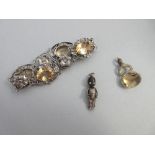 A citrine set bracelet together with a citrine swivel fob and a 'Fumsup' WWI good luck charm, the