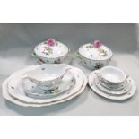 A Herend porcelain dinner service for twelve, painted with floral bouquets supported by sprigs of