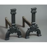 A pair of 16th century Gothic Andirons, the capped pillars with hatched decoration, a shield