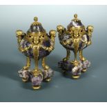 A pair of early 19th century ormolu and marble cassolettes, the reversible nozzles within a bun