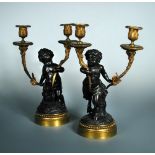 A pair of 19th century bronze and ormolu two light candelabra, one supported by a Putto and the