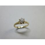 A single stone diamond ring, the round brilliant cut diamond of approximately 0.40ct in a raised six