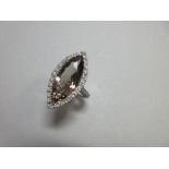 A smoky quartz and diamond cocktail ring by Pascal, the large marquise cut smoky quartz in a