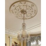 A ten branch cut glass chandelier, with two tiers and branches, swag lustres and hanging central