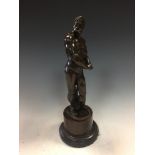 A late 18th / early 19th century bronze figure of Hercules, the standing naked figure holding his