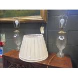 A pair of cut glass table lamps with brass mounts