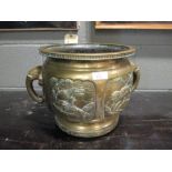 A Chinese two handled jardiniere, the sides embossed with panels depicting animals, with elephant