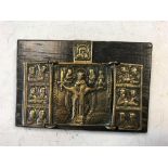 A small Russian bronze folding devotional icon, on an oak mount bearing an old label 'Picked up on a