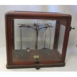 A mid 20th century mahogany cased set of scientific scales, with ivorine label 'Model 21a' 65 x 61cm